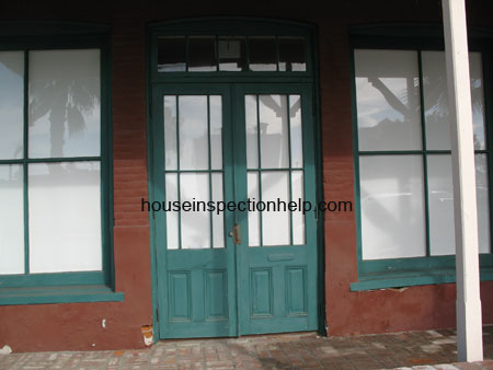 old wood windows with green double door