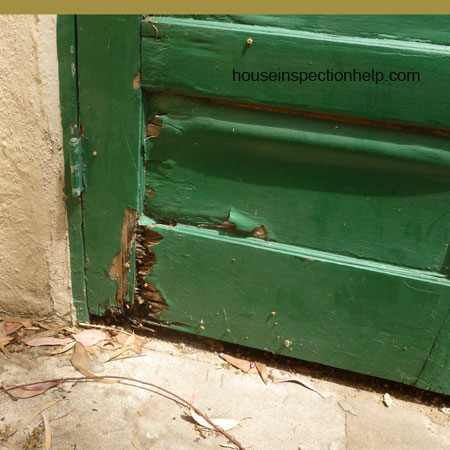 exterior wood door with water damage and paint flaking